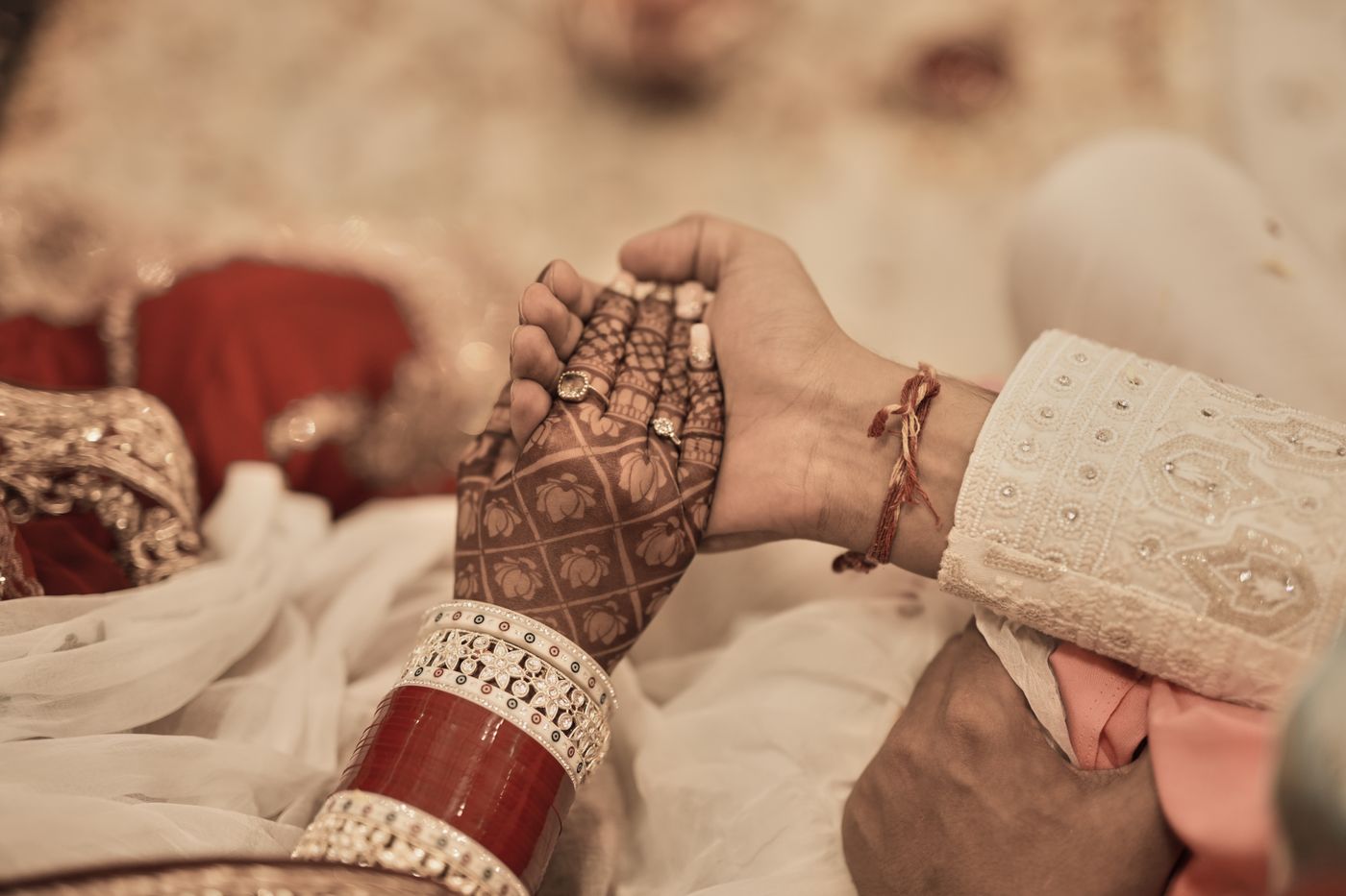 hands of a couple at a traditional Indian nikah ceremony