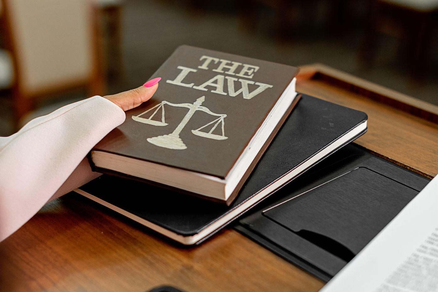 statute book and scales of justice on a lawyer's desk
