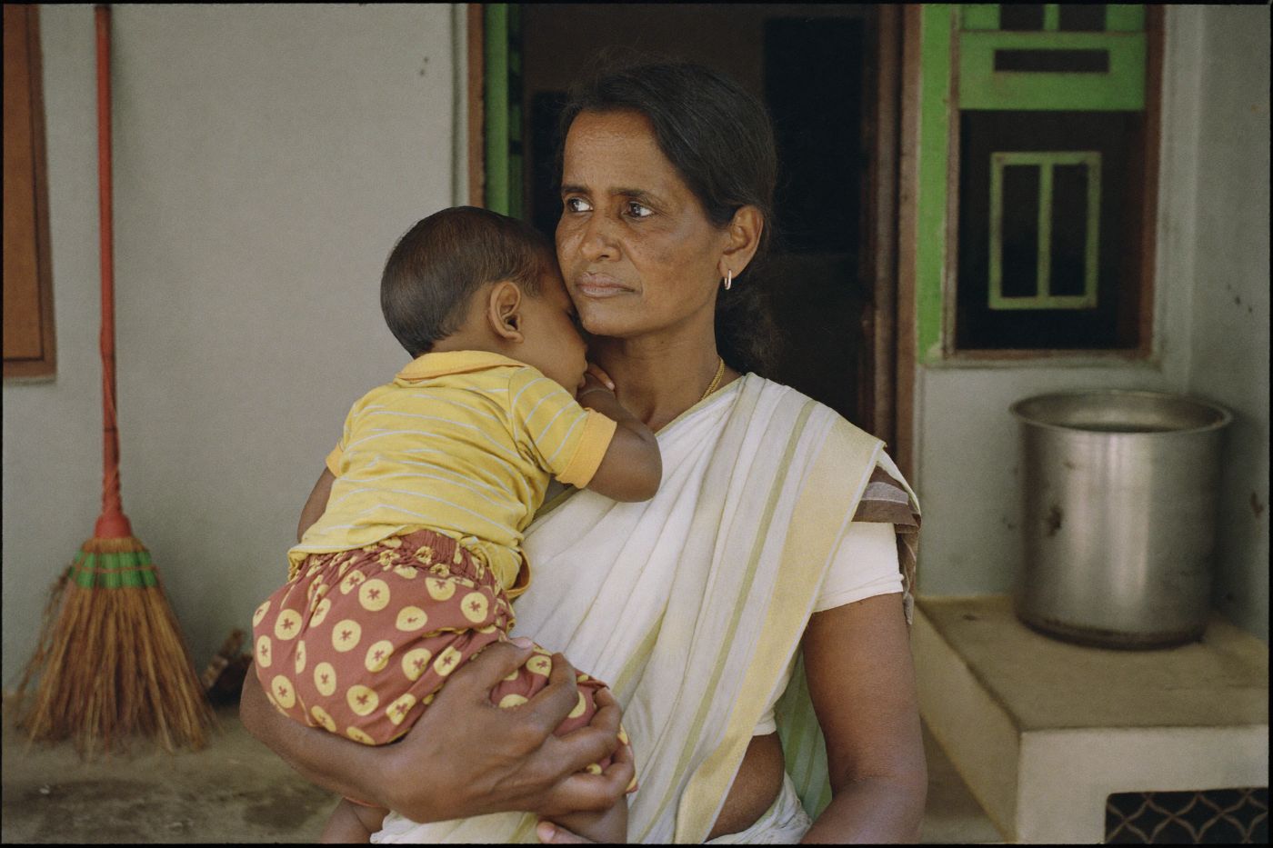 woman carrying her child, photographed in India