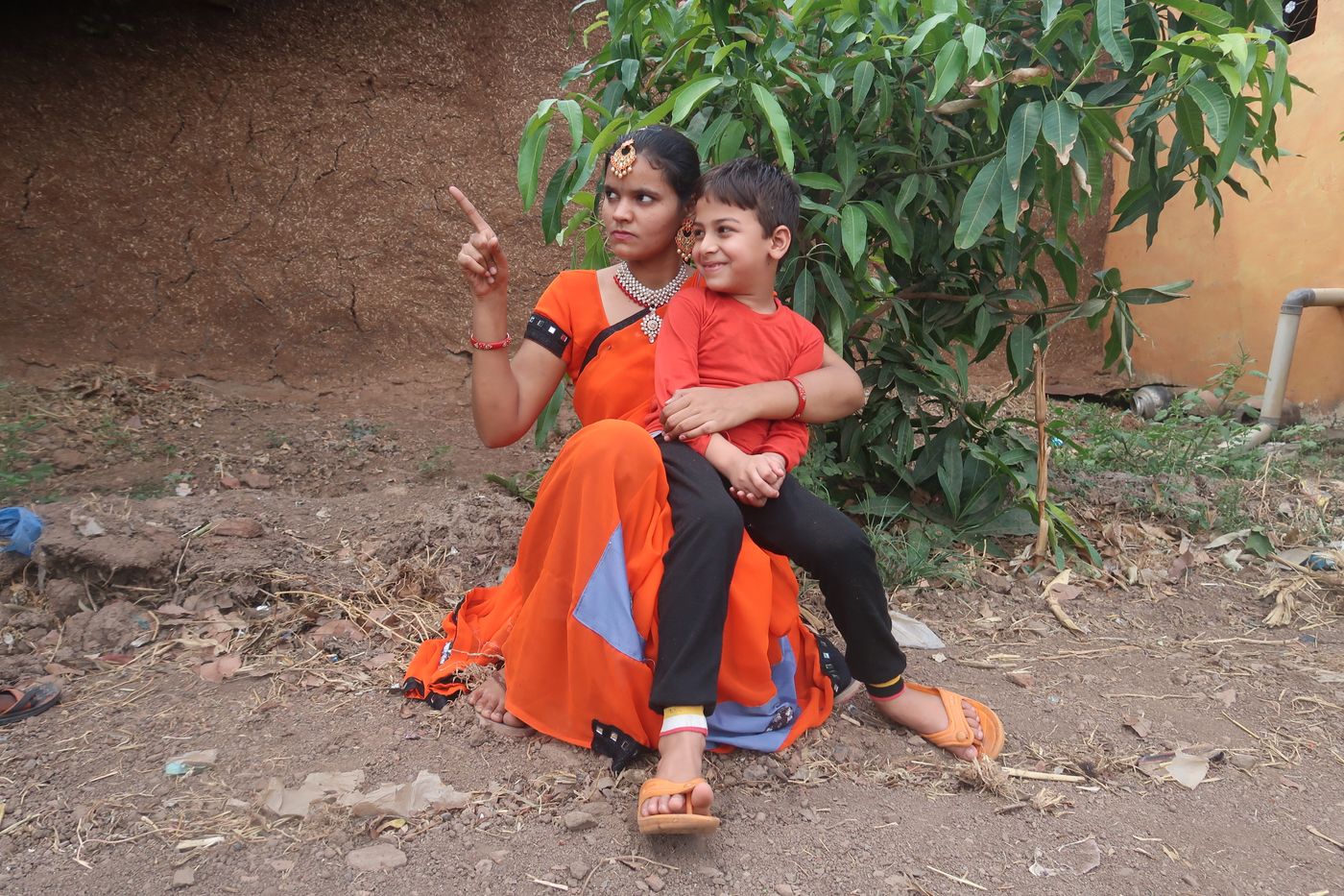 mother with her children outside their home in Tamil Nadu
